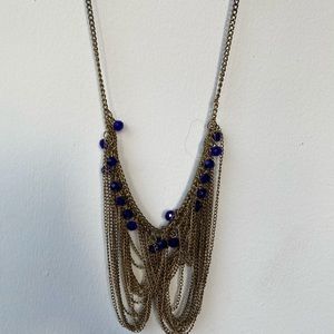 Gold chain necklace with blue bead detail